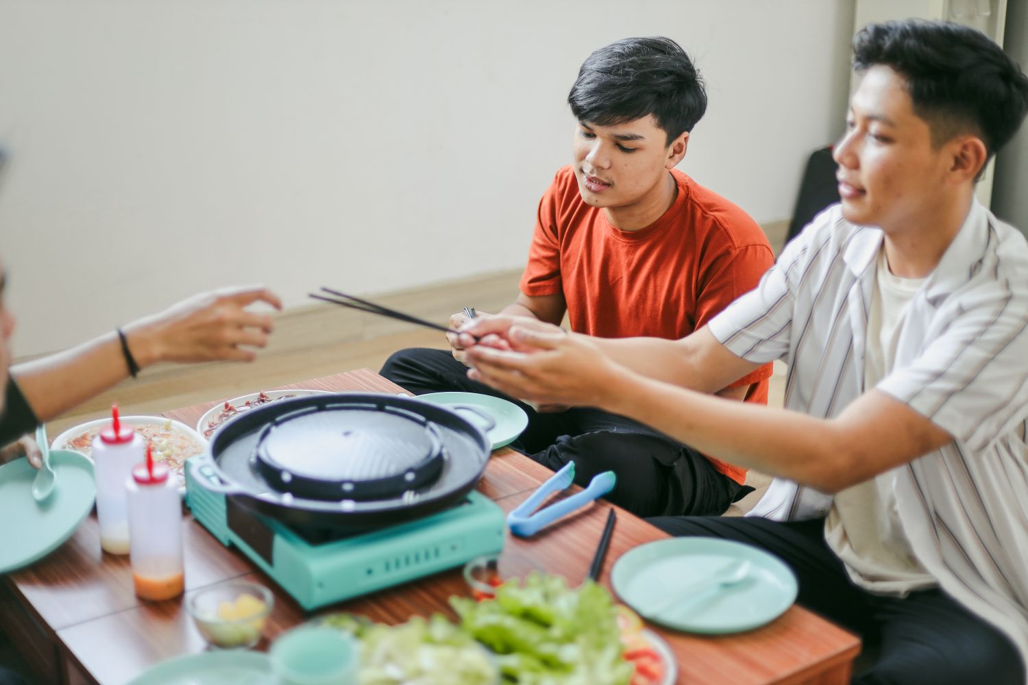 friends around an electric pan